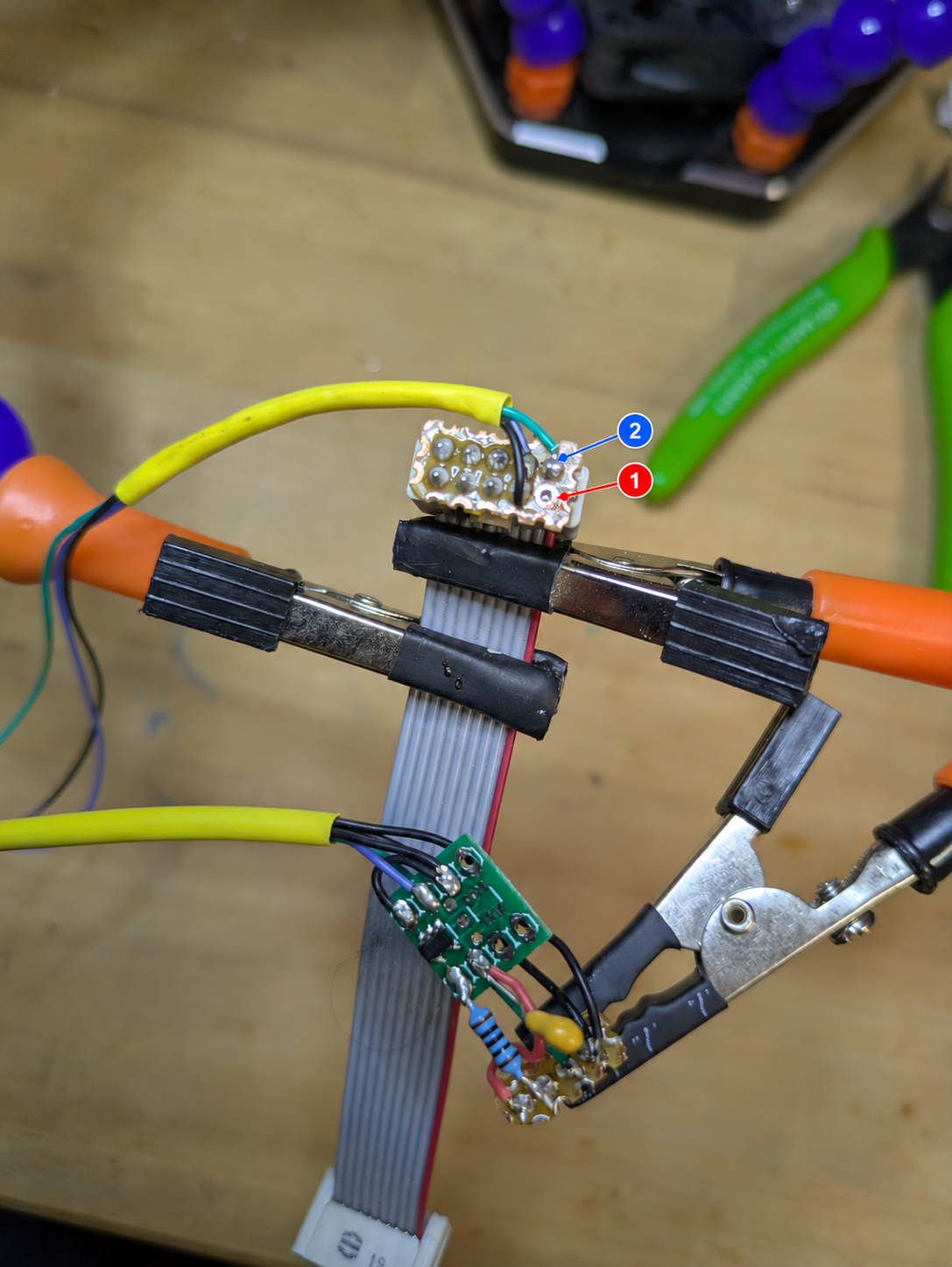 Robot-side 10-pin service connector head and UART signal-conditioning circuit; red and blue markers identify the pin 1 and pin 2 contacts